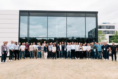 A large group of people standing in front of an office building