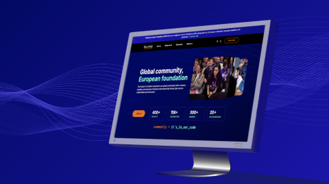 Computer monitor showing the updated Eclipse Foundation website with new colours, typography, and community imagery.